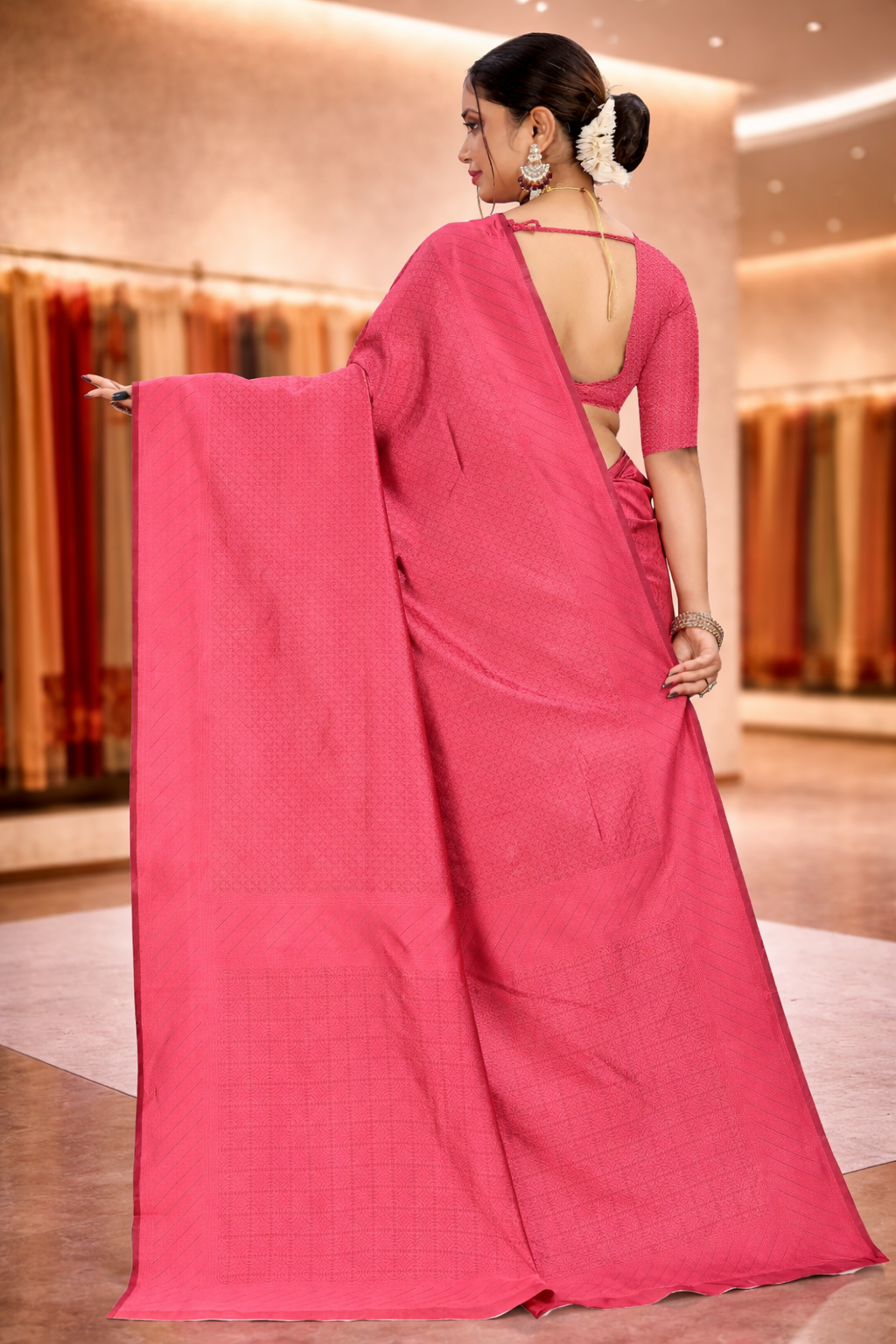 Back view of a model elegantly draped in a gaajri pink solid art silk saree