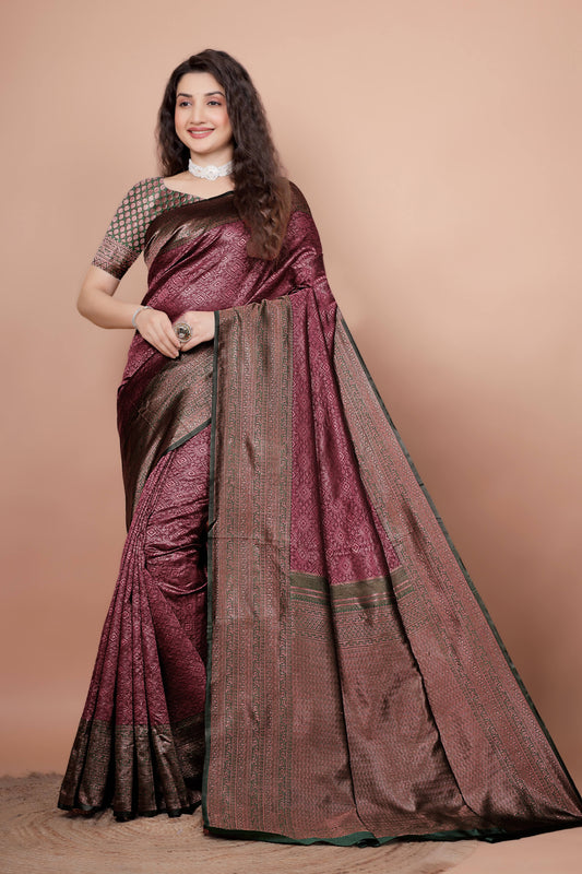Woman modeling a beautiful maroon and green woven silk saree
