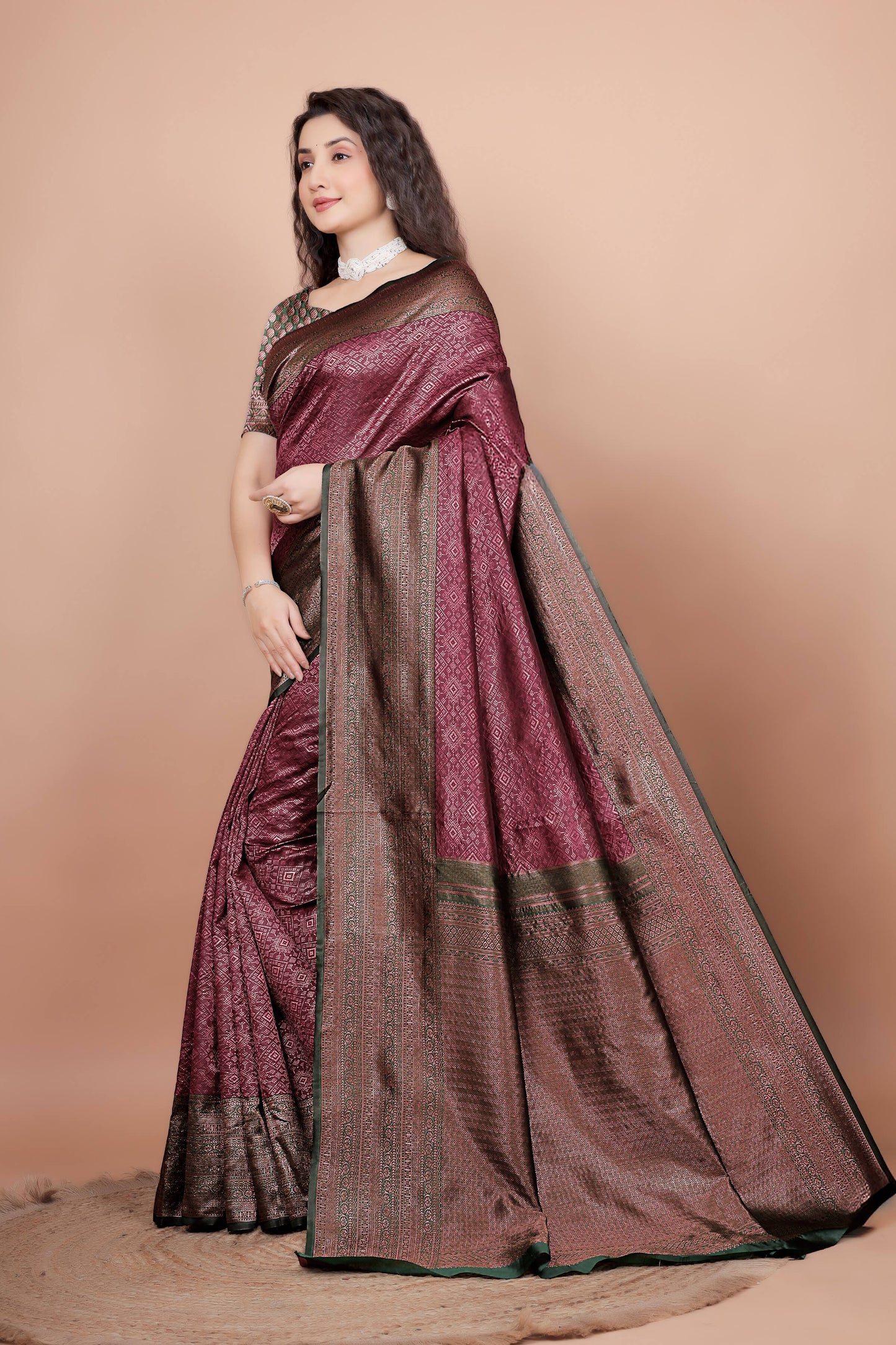 Side view of maroon jacquard saree showing green zari border