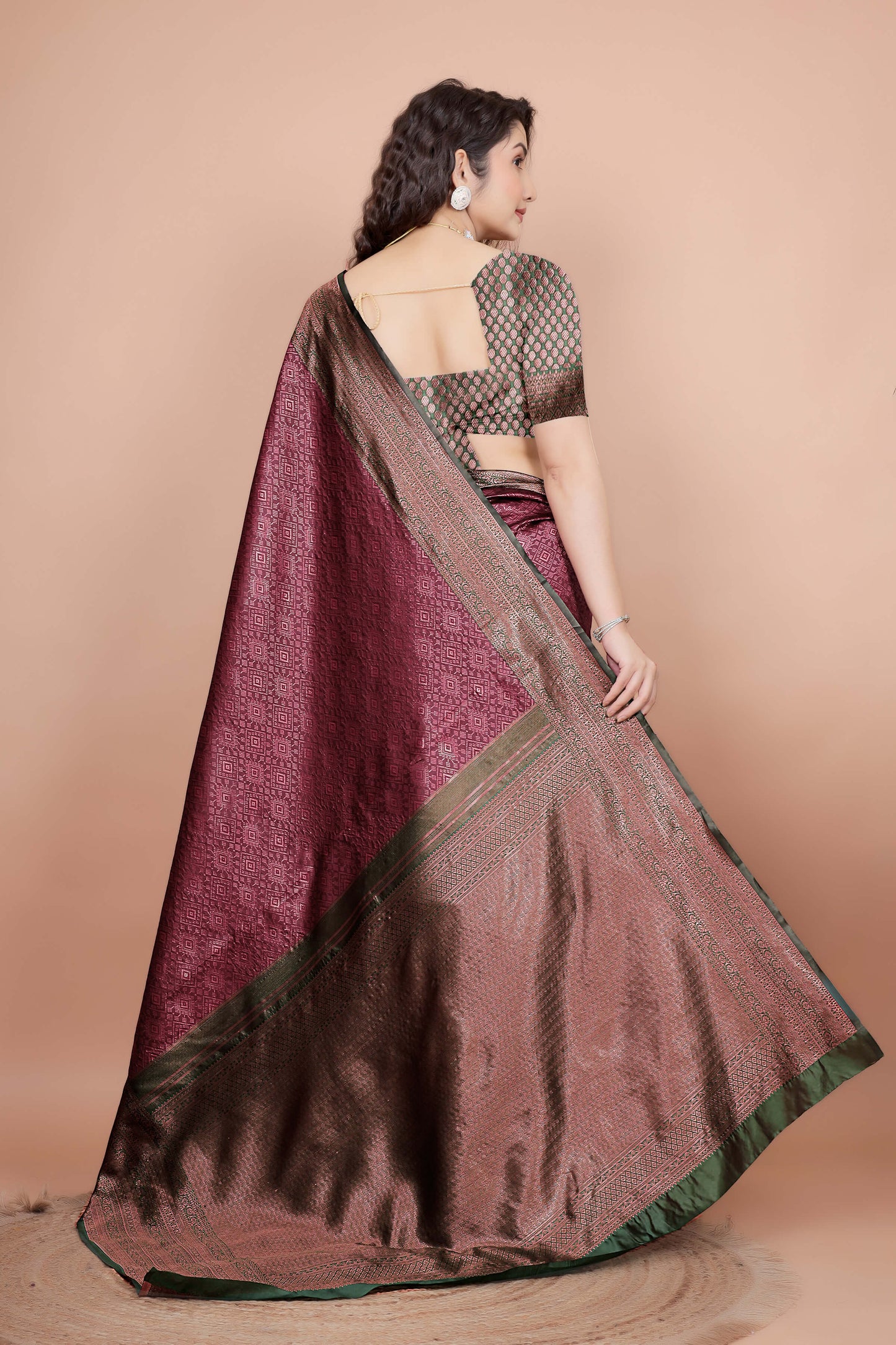 Back view of green woven blouse design with maroon saree drape