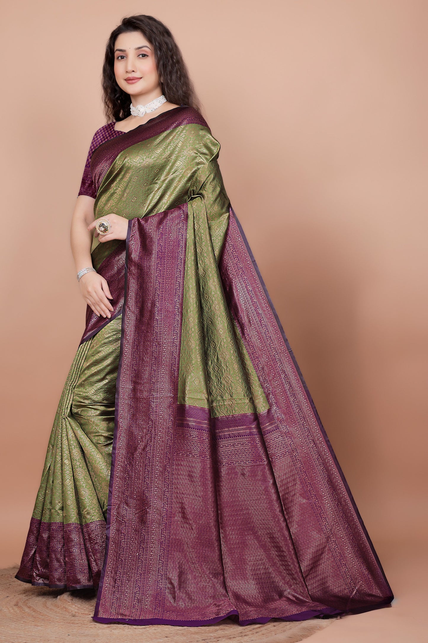 Side angle showcasing the rich cherry pallu and mehndi green pleats