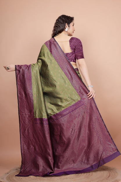 Back view highlighting the textured cherry blouse and the flowing woven pallu