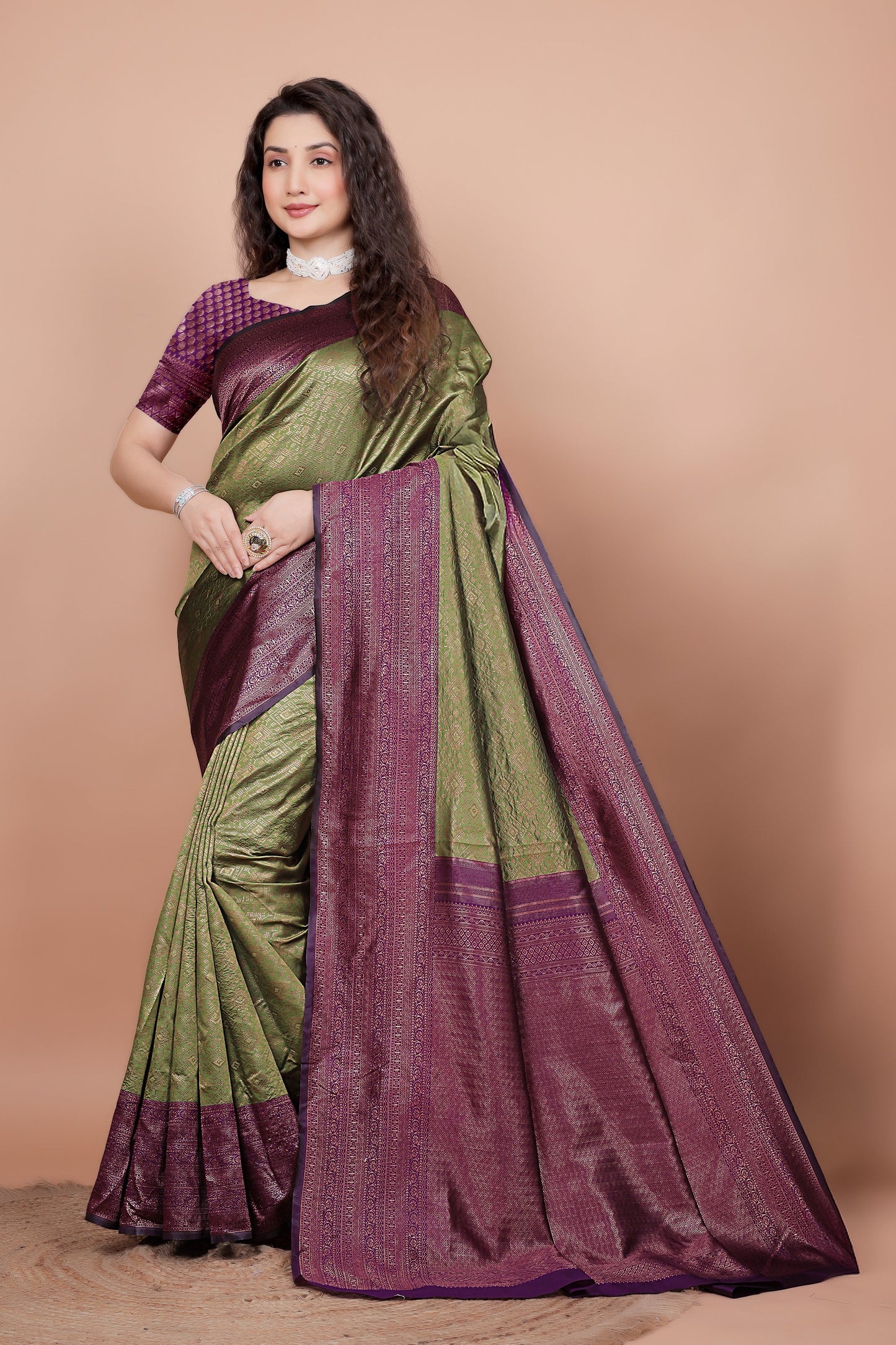 Full front view of a woman wearing a mehndi green and cherry red woven silk saree