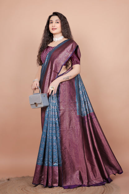 Model elegantly draped in a peacock blue and wine silk saree, posing with a stylish handbag