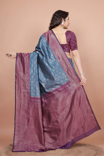 Back view highlighting the textured wine blouse and the flowing woven zari pallu