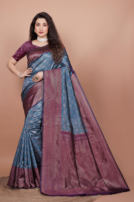 Full front view of a woman wearing a peacock blue and wine woven silk saree