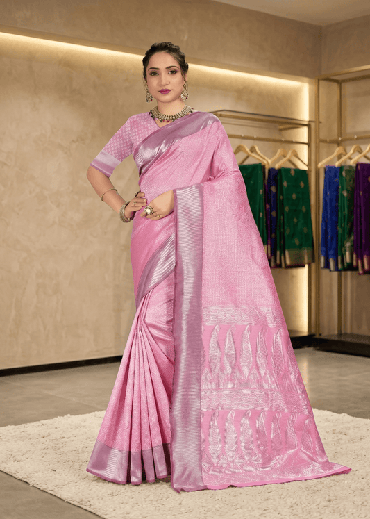 Full front pose showing the rich texture and elegant fall of the pink traditional saree