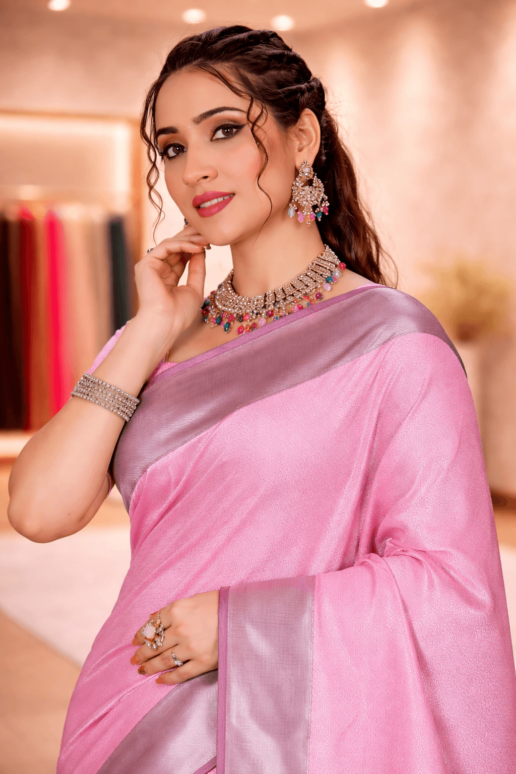 Close-up profile of a woman wearing a pastel pink monotone silk saree with matching jewelry