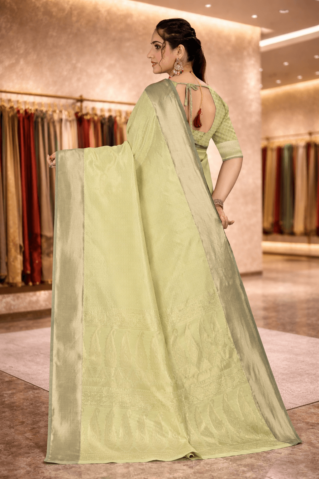 Back view highlighting the intricate woven paisley pallu of the pistachio green saree