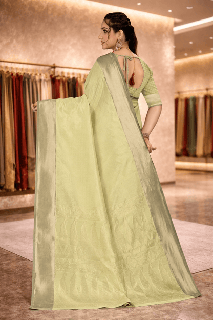 Back view highlighting the intricate woven paisley pallu of the pistachio green saree