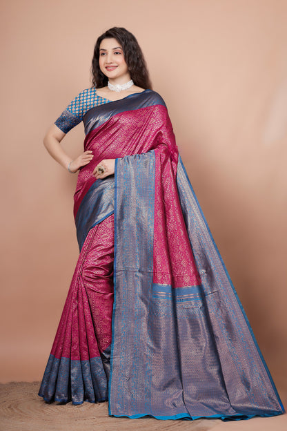 Model elegantly posing in a vibrant rani pink and peacock blue woven silk saree