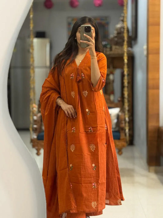 Full-length mirror selfie showcasing a beautiful burnt orange flared suit set with matching pants and a gracefully draped dupatta.