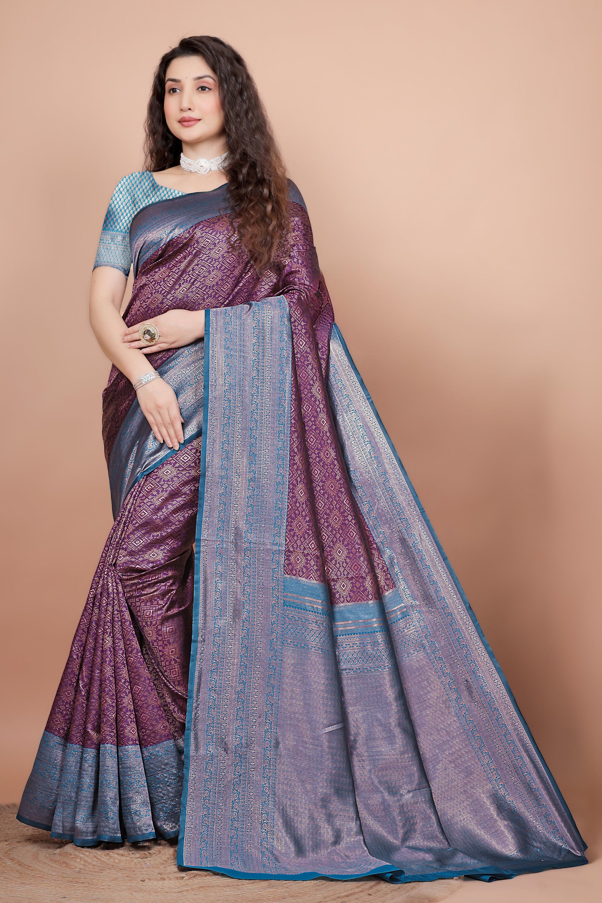 Full front view of a woman wearing a deep wine and peacock blue woven silk saree